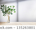 Light and shadow in a bright room with sunlight streaming in and eucalyptus leaves in a glass 135263801