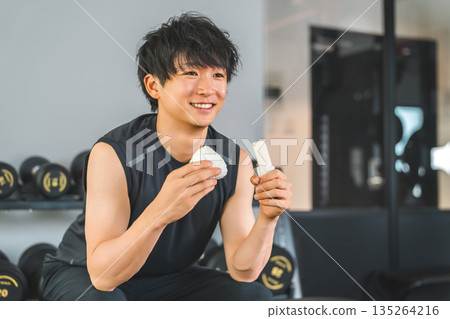Young Asian man doing muscle training refueling before and after training 135264216
