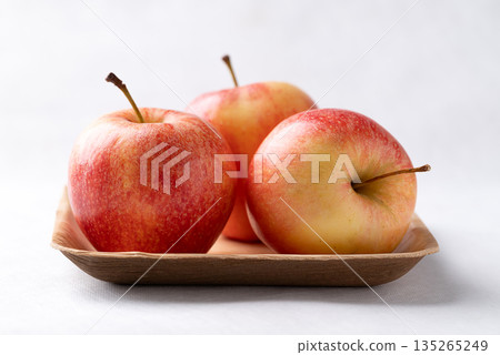 Red apple fruit (Gala apple) in natural plate on white background Red apple fruit (Gala apple) in natural plate on white background 135265249