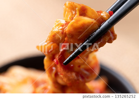 Kimchi cabbage with chopsticks, Korean food Kimchi cabbage with chopsticks, Korean food 135265252