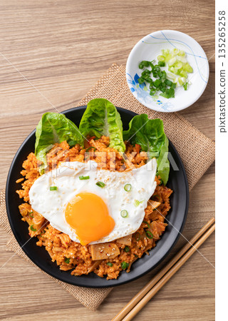 Korean kimchi fried rice with fried egg and spring onion on top Korean kimchi fried rice with fried egg and spring onion on top 135265258