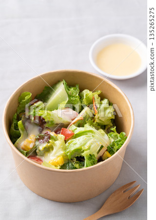 Healthy vegetable salad in takeout bowl with salad dressing ready to eating Healthy vegetable salad in takeout bowl with salad dressing ready to eating 135265275