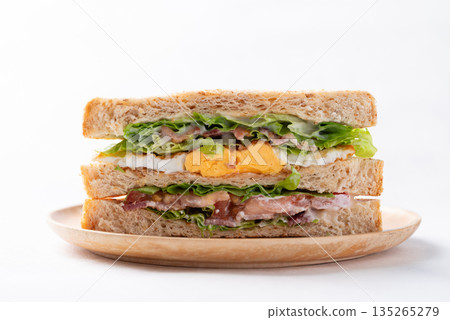 Whole wheat bread sandwich with bacon, lettuce, tomato and fried egg 135265279
