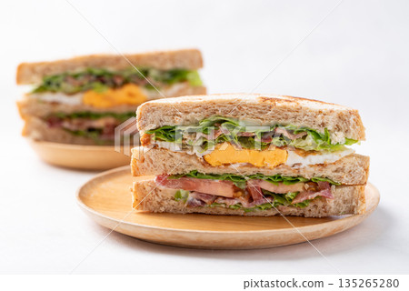 Whole wheat bread sandwich with bacon, lettuce, tomato and fried egg 135265280