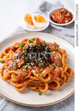 Stir fried Udon noodle with kimchi cabbage, pork, spring onion, sesame seed and seaweed on top Stir fried Udon noodle with kimchi cabbage, pork, spring onion, sesame seed and seaweed on top 135265291