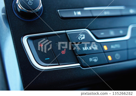 Car seat heating and climate control buttons close up 135266282