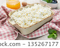 Cottage cheese in bowl with honey and blueberries 135267177