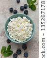 Cottage cheese bowl with fresh blueberries and mint leaves 135267178