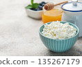 Cottage cheese in bowl with honey and blueberries breakfast 135267179