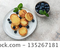 Syrniki cottage cheese pancakes with blueberries and mint 135267181