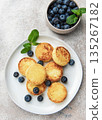 Syrniki cottage cheese pancakes with blueberries and mint 135267182