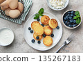Syrniki cottage cheese pancakes with fresh blueberries and mint breakfast 135267183