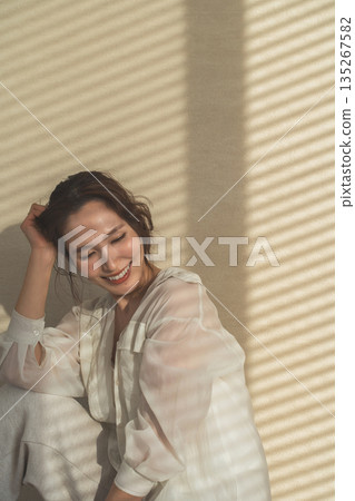 A woman by the window in the setting sun (model, fashion, light, shadow) A woman by the window in the setting sun (model, fashion, light, shadow) 135267582