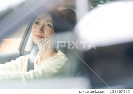 A woman driving a car A woman driving a car 135267955