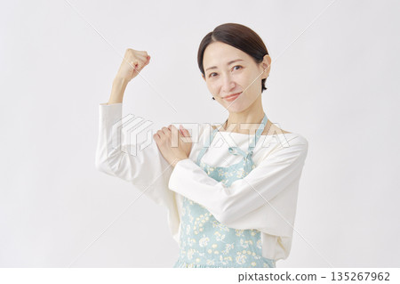 Woman wearing an apron, motivated gesture, white background 135267962