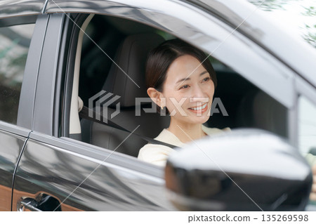 A woman driving a car A woman driving a car 135269598