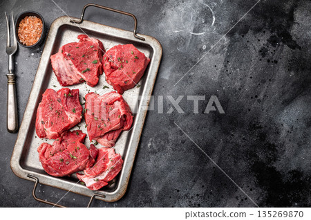 Raw beef boneless shank shin meat with herbs and spices ready for cooking. isolated on white background. top view Raw beef boneless shank shin meat with herbs and spices ready for cooking. isolated on white background. top view 135269870