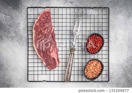 Fresh raw top sirloin steak, showcasing its rich color and marbling. grey background. top view 135269877