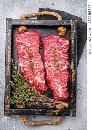 Exquisite beef shoulder tender, denver steak waiting to be transformed into a gourmet dish. Ideal for grilling or roasting for an unforgettable dinner. grey background. top view 135269895