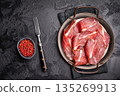 Thin slices of Speck, Jambon Italian cured meat. black background. top view 135269913