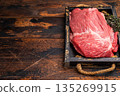 Unccoked Top Round beef, raw topround roast meat with thyme. wooden background. Top view 135269915