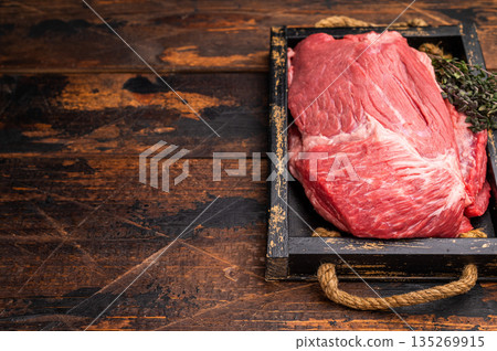 Unccoked Top Round beef, raw topround roast meat with thyme. wooden background. Top view Unccoked Top Round beef, raw topround roast meat with thyme. wooden background. Top view 135269915