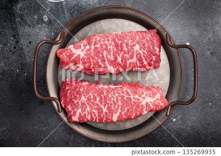 Premium denver, chuck eye steak, beautifully presented, ready for seasoning. A versatile cut ideal for barbecue enthusiasts and steak lovers alike. black background. top view Premium denver, chuck eye steak, beautifully presented, ready for seasoning. A versatile cut ideal for barbecue enthusiasts and steak lovers alike. black background. top view 135269935