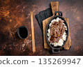 Exquisite Japanese BBQ, highlighting beautifully charred meats and rice. Perfectly seasoned, this dish promises a rich and savory flavor in every bite. brown background. top view 135269947