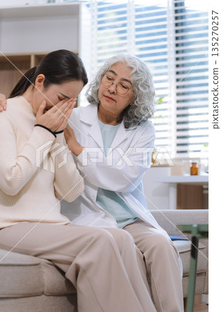 Stressed female patient are treated by a psychologist or psychiatrist in a psychiatric clinic or hospital. Stressed female patient are treated by a psychologist or psychiatrist in a psychiatric clinic or hospital. 135270257