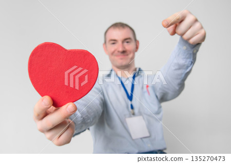 Smiling cardiologist doctor holding a healthy heart in his hands Smiling cardiologist doctor holding a healthy heart in his hands 135270473