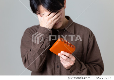 一位身著休閒裝的中年男商人正為自己的皮夾擔憂。 135270722