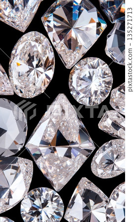 Sparkling diamonds ranging from brilliant cut to emerald cut gleaming against deep black velvet, showcasing luxury jewelry's refined elegance and luminous radiance 135271713