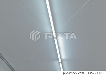 Fluorescent Light Illuminating Ceiling with Copy Space for Text, Graphics, or Logos for Commercial Interior Design Applications Fluorescent Light Illuminating Ceiling with Copy Space for Text, Graphics, or Logos for Commercial Interior Design Applications 135273479