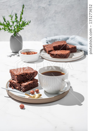 Pieces of chocolate brownie on a plate and a cup of espresso coffee on a marble background 135273652