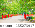Red bridge shines in fresh green 135273917