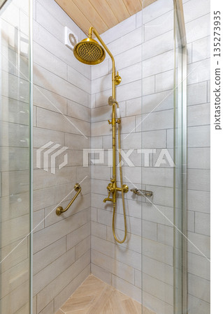 Vintage brass shower set in a rustic bathroom interior Vintage brass shower set in a rustic bathroom interior 135273935