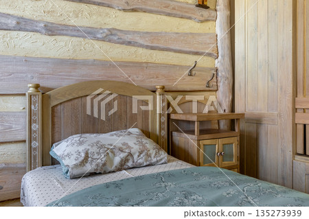 Traditional rustic bedroom with folk art bed and log wall decor Traditional rustic bedroom with folk art bed and log wall decor 135273939