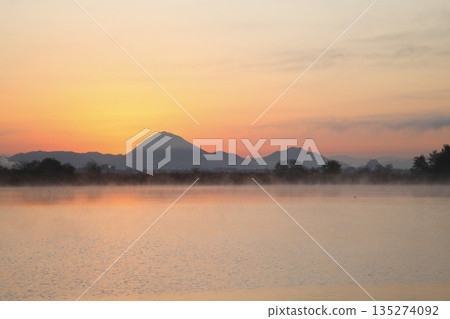 Mount Mikami at sunrise as seen from Lake Kihamauchi Mount Mikami at sunrise as seen from Lake Kihamauchi 135274092