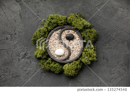 Yin Yang Zen Garden with Green Moss on Dark Stone Background Yin Yang Zen Garden with Green Moss on Dark Stone Background 135274548