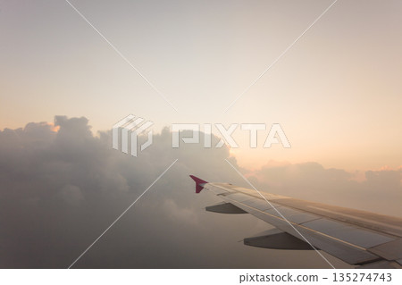 View from plane window, cloud sky View from plane window, cloud sky 135274743