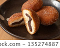Close-up of a cross section of an anko donut cut in half 135274887