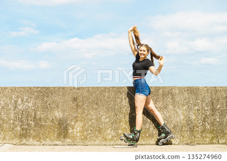 Fit girl with roller skates outdoor Fit girl with roller skates outdoor 135274960