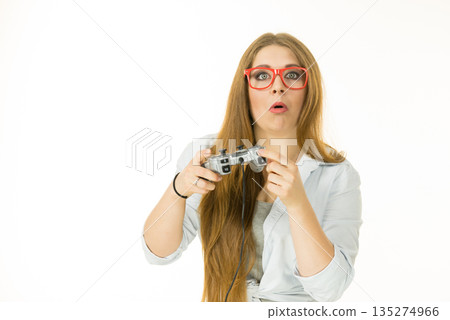 Woman trying to understand gaming pad Woman trying to understand gaming pad 135274966