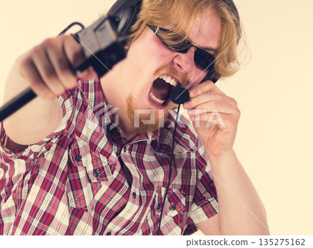 Gamer man shooting from gun Gamer man shooting from gun 135275162