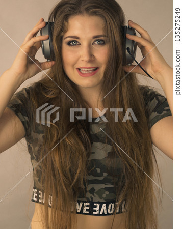 Teen women wearing headphones Teen women wearing headphones 135275249