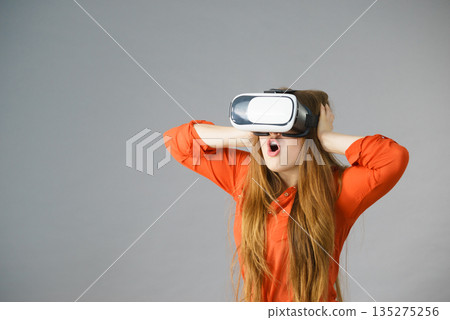 Girl wearing virtual reality goggles. 135275256
