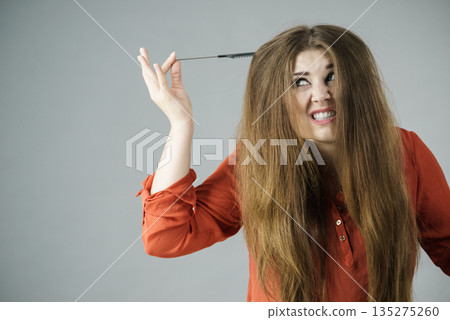 Woman having tangled hair Woman having tangled hair 135275260