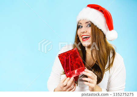 Happy Christmas woman holds red gift bag Happy Christmas woman holds red gift bag 135275275