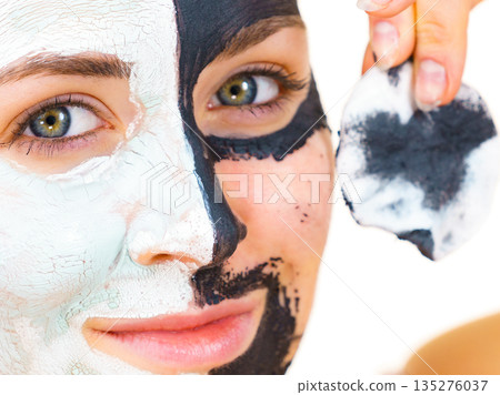 Girl remove black white mud mask from face 135276037