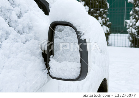 Vehicles sit completely buried under thick layer of snow on quiet urban residential street. Record snowfall, urban blizzard, climate crisis impact, extreme weather, city infrastructure challenges. 135276077